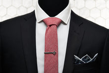 A mannequin modelling Dear Martian accessories, which features our red chambray skinny tie, fleur de lis tie clip, and camo blue pocket square.