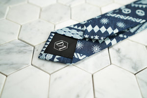 The back of the celtic and skull patterned skinny tie displays the exclusive DM stitched hexagonal logo.