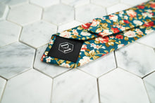 An image that portrays the DM signature hexagonal logo on the back of the Posie floral necktie made by Dear Martian, Brooklyn.