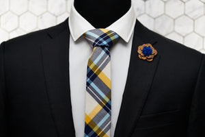 A Dear Martian mannequin is dressed up in a madras skinny necktie and is paired with a wooden flower lapel pin.