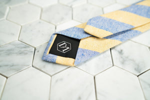 The back of the yellow and blue striped linen tie made by Dear Martian, Brooklyn.